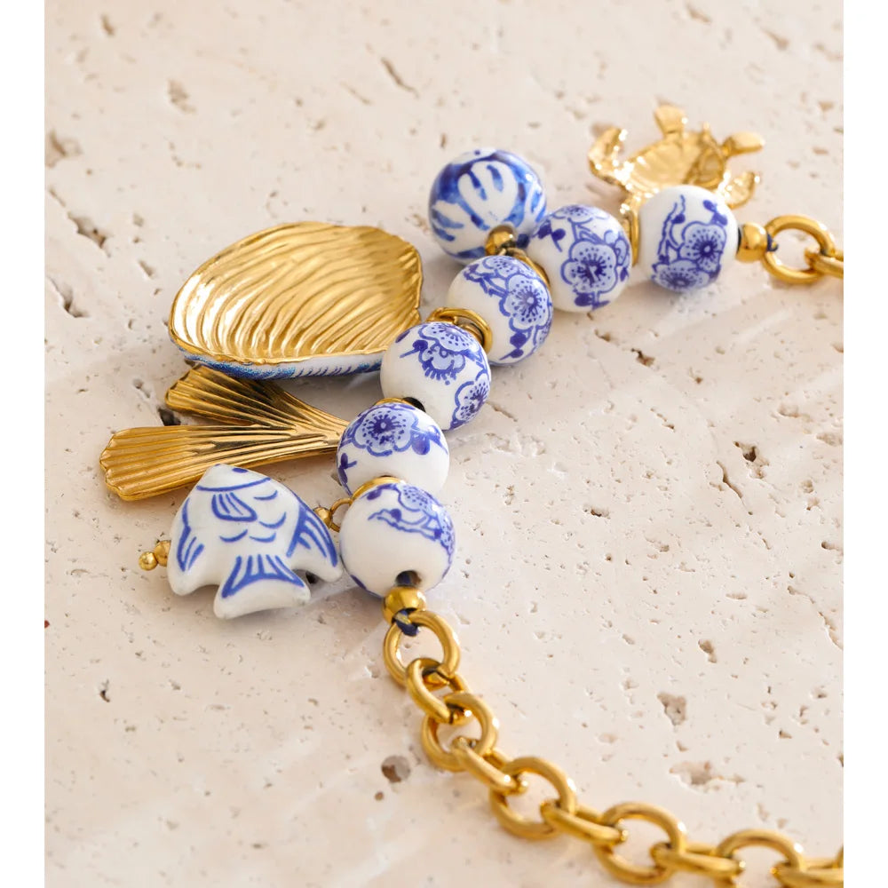 Ocean Catch — Stainless Steel Blue Ceramic Bead Fish & Shell Drop Statement Necklace